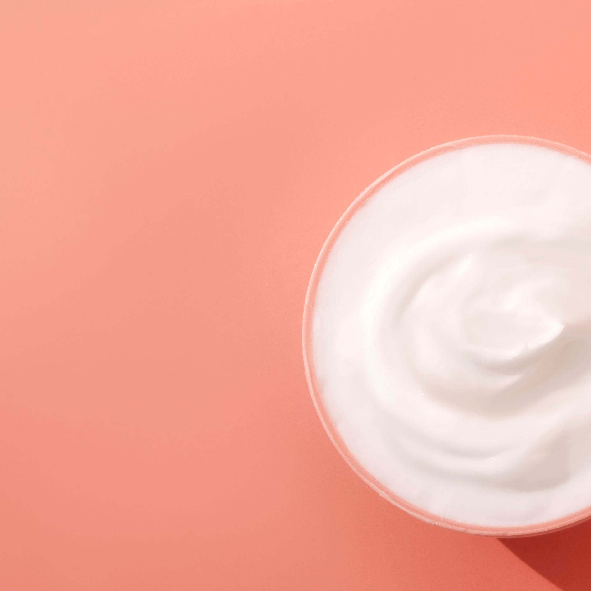 Decorative Image of white body cream with peach background
